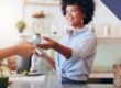 Hospitality employee accepting a customer payment representing secure connected payments through Bluefin and 934 Juno