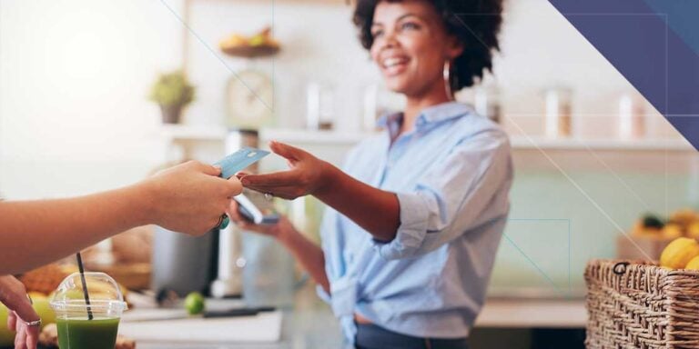 Hospitality employee accepting a customer payment representing secure connected payments through Bluefin and 934 Juno