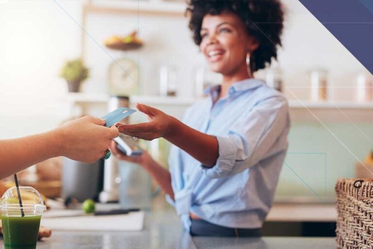 Hospitality employee accepting a customer payment representing secure connected payments through Bluefin and 934 Juno